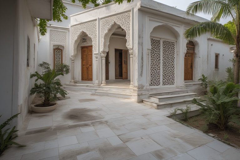 Elegant white village single floor home front design with intricate jali work and light-reflecting tiles