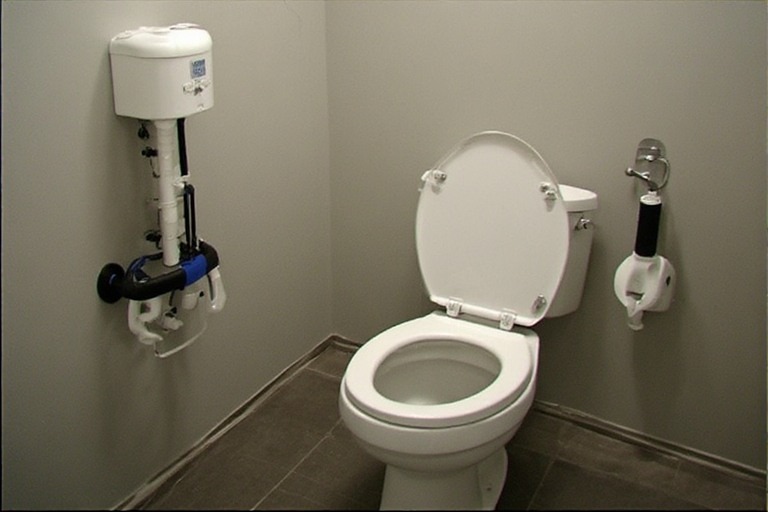 Accessible slim flush tank panel.